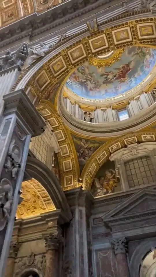 Travel ad looking up into the gilded dome and frescoes of a basilica