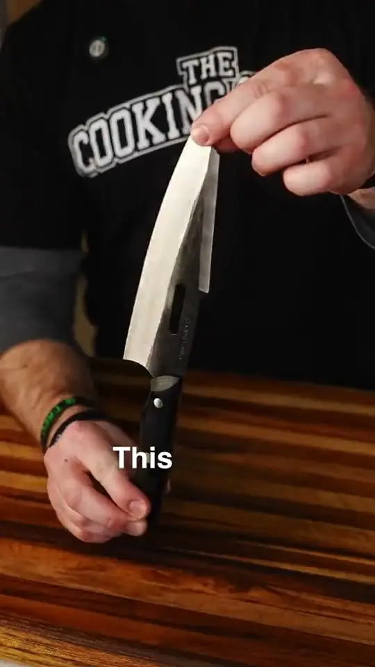 Kitchen knife ad: a chef lifts the blade over a wooden board